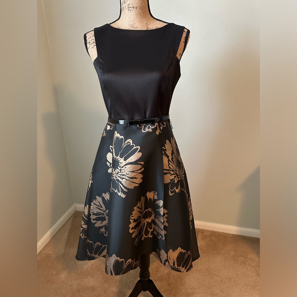 Donna Ricco Sleeveless Formal. High & low length. Black w/gold print. Size 6.